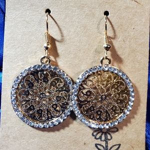 Gold Medallion encrusted with clear jewels. Dangle and hook design. Stunning.